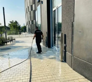 Power washing side walk and facade of commercial facility in NYC